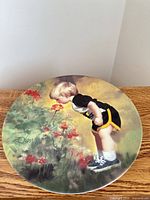 Full view of plate displaying artwork of boy in garden