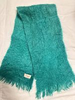Full view of teal mohair scarf laid flat
