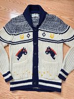 Full front of cream and navy horse motif cardigan