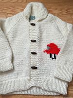 Full view of cardigan front showing buttons and firetruck motif