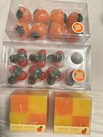 Box of peach-shaped candles above box of cherry-shaped candles; two Ginger Jewel boxes