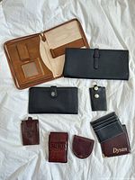 Overview of all eight leather and leatherette items laid flat
