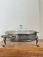 Full side view of casserole set assembled in stand