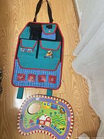 Full view of Winnie the Pooh car organizer and farm foam mat piece on floor