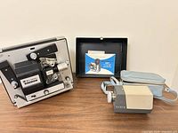 Projector, Cabin viewer, paperwork in open case displayed on table