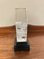 Crystal glass column on black base, full view