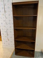 Full front view of bookcase showing five shelves and overall design