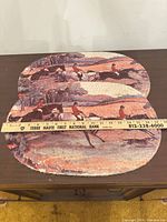 pair of oval fox-hunt cotton braided placemats measured against ruler