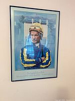 Front view of framed jockey print on wall