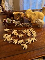 Group of elephant figurines and chain on table
