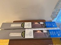 Two boxed blinds showing brand, dimensions, and packaging