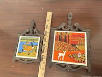 Front view showing both trivets, ruler for scale