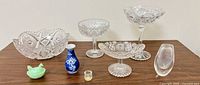 Group shot of all eight glass and porcelain items on table