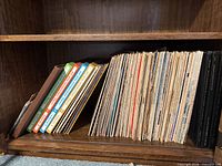 Shelf section showing 7" storybook records with coloured spines and stack of LP albums