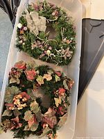 Both wreaths in storage bin showing size and seasonal styles