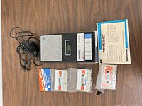 Top view of Panasonic RQ-209S recorder, AC adaptor, three sealed tapes, instruction sheet