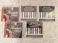 Front covers of all five sealed CDs