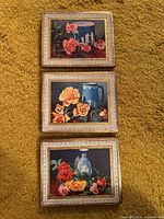 Front view of all three floral rose wood plaques showing images and metallic borders