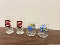 Front view of all four glasses showing team logos and glass styles