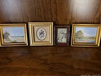 Front view of all four framed artworks showing subjects and frame styles
