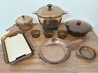 Full set arranged on table showing all pots, lids, skillet, baking dish, insert and bowls