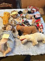 overview of all dolls and plush animals on table