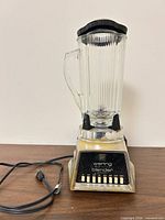 Full assembled blender front view displaying base, pitcher, lid and power cord