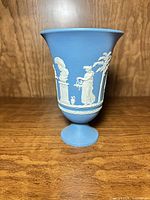 Front view of vase showing light blue body and white relief