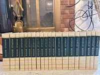 Row of 18 World Book encyclopedia hardcovers A–T with cream and green spines