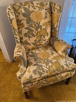 Front view of wingback chair showing upholstery, cushion, legs