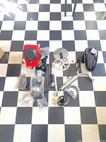 Full kit layout showing engine, fuel tank, exhaust, sprockets, hardware, cables