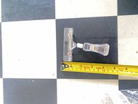 Wide clear plastic display clip with tape measure for scale