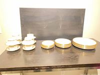 Group view of cups, saucers and three plate stacks