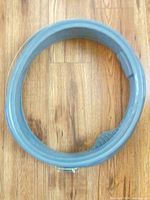 Grey rubber door boot gasket coiled on floor