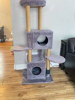 Full view of cat tree showing base, cubbies, platforms, posts, and top perch