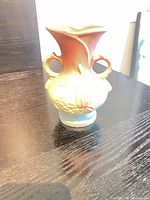 Front view of Hull Magnolia vase showing color gradient, floral relief and handles