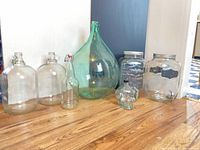 Front view of glass demijohn, carboys, swing-top bottle, skull bottle, beverage dispensers