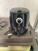 Front view of Magic Bullet air fryer showing power cord and handle
