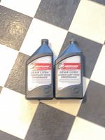 Front view of both sealed Mercury gear lube 1L bottles on tiled floor