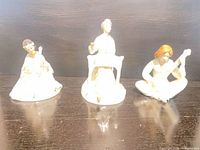 Front view of the three Royal Doulton Enchantment Collection figurines