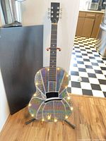 Full view of decorative guitar on stand with LEDs illuminated