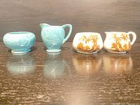 Four ceramic pieces lined up showing both Ridgway blue and Lancaster brown sets