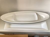 Stack of three platters showing rectangular and oval shapes