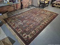 Full view of rug showing pattern, colors, and distress