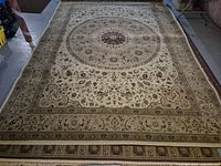 Full view of entire rug showing size, central medallion, and border