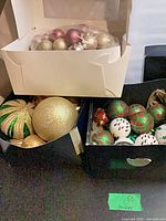 Three boxes containing assorted plastic Christmas ornaments