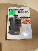 Front of retail box showing juicer image and branding