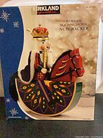 Front of original box showing rocking horse nutcracker graphic