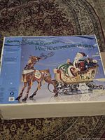 Front of product box showing Santa in sleigh pulled by reindeer illustration
