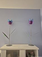 Both metal tulip candle holders full view